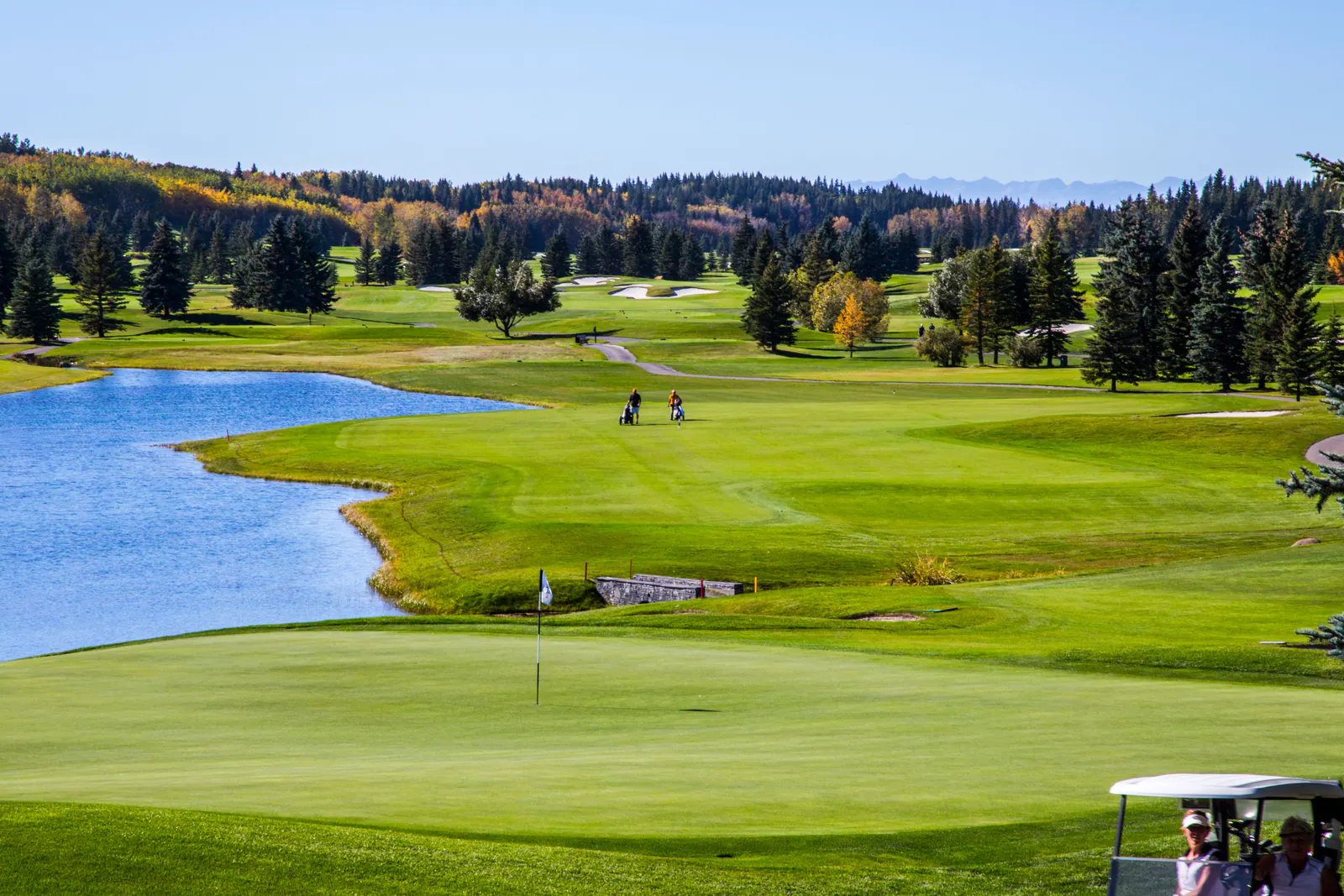 Fairways, a still lake and mixed forest in Elbow Valley west of Calgary