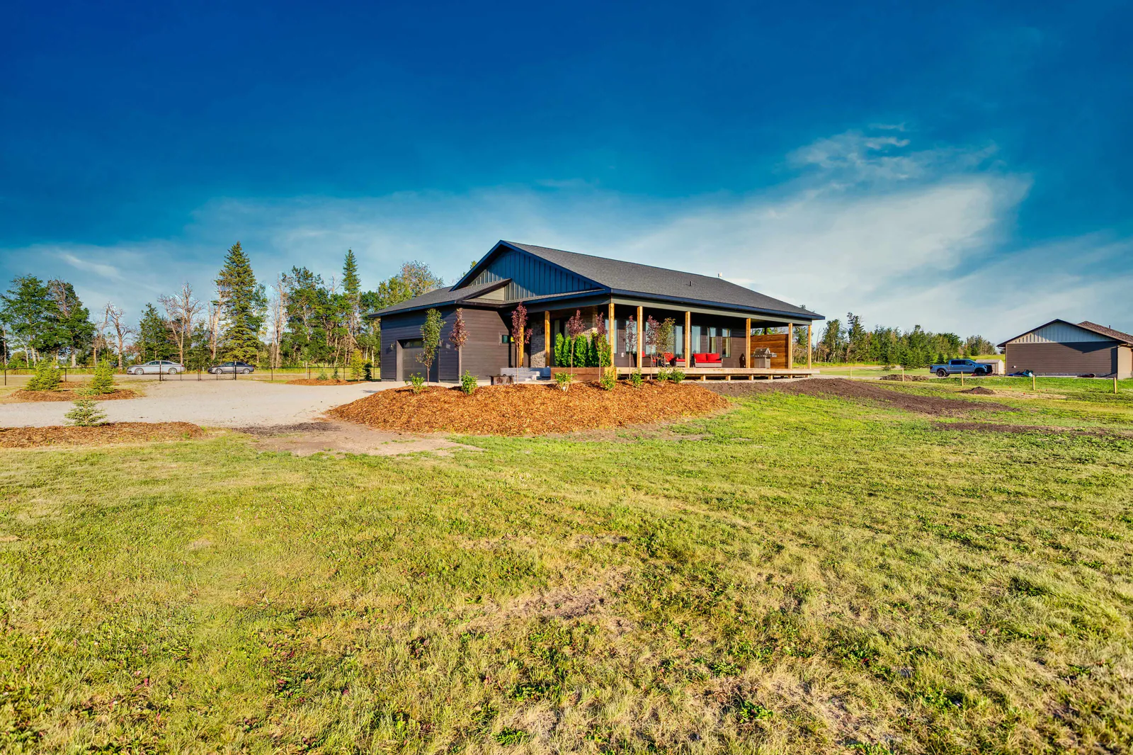 The home viewed across the lawn and open acreage