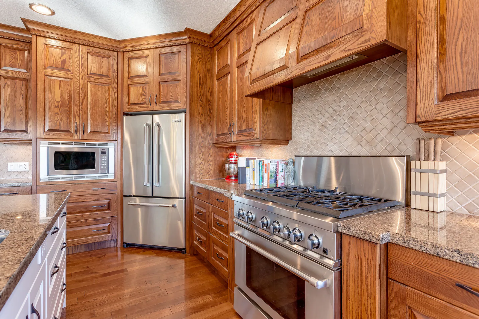 Kitchen with full-length custom cabinetry and a six-burner range