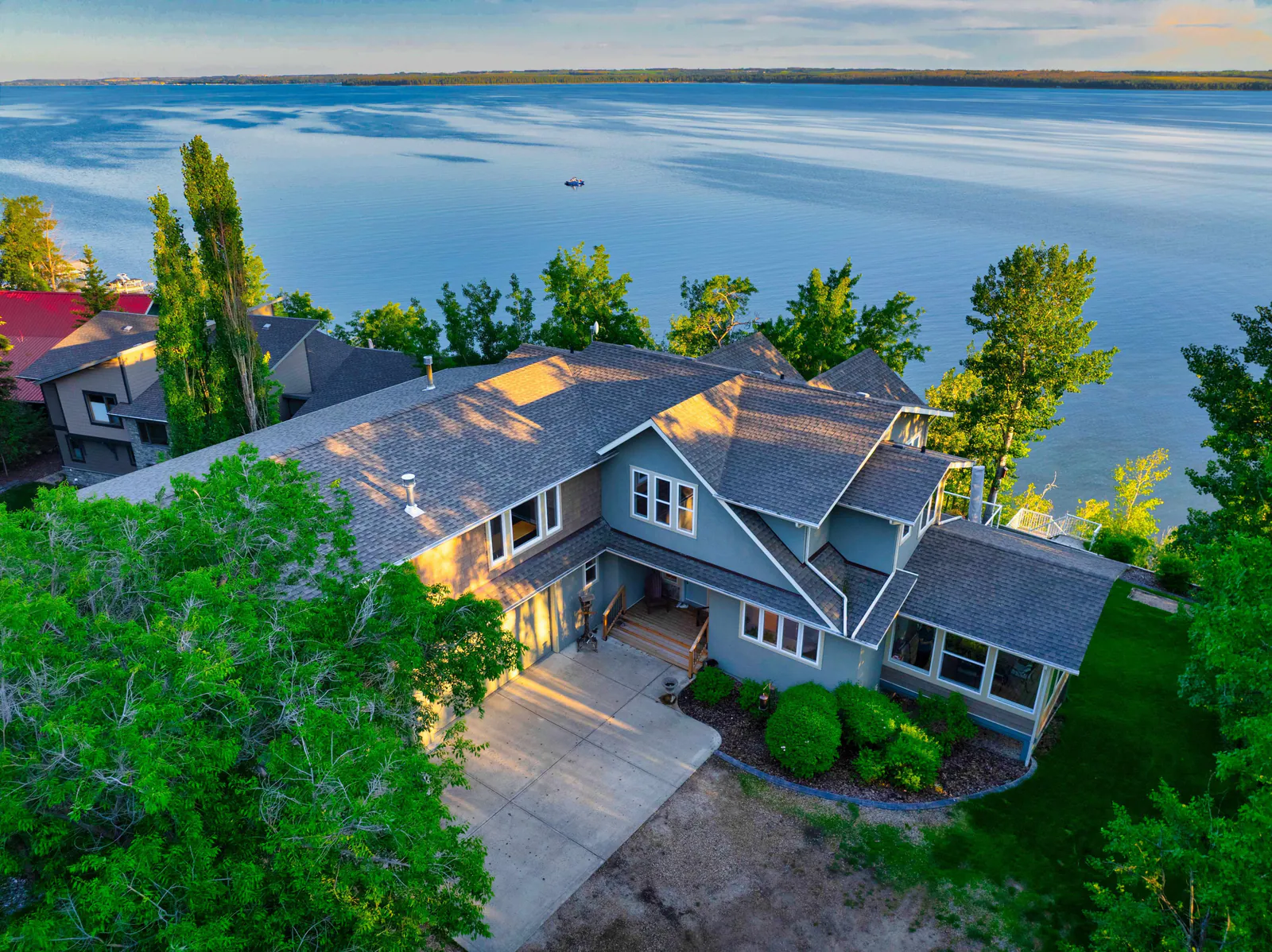 The home with the lake beyond in evening light