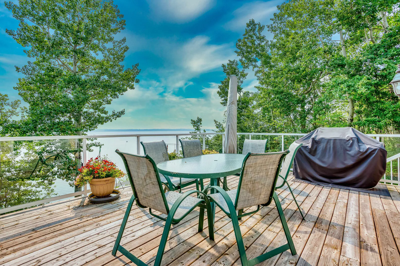 Upper deck dining area with a lake view