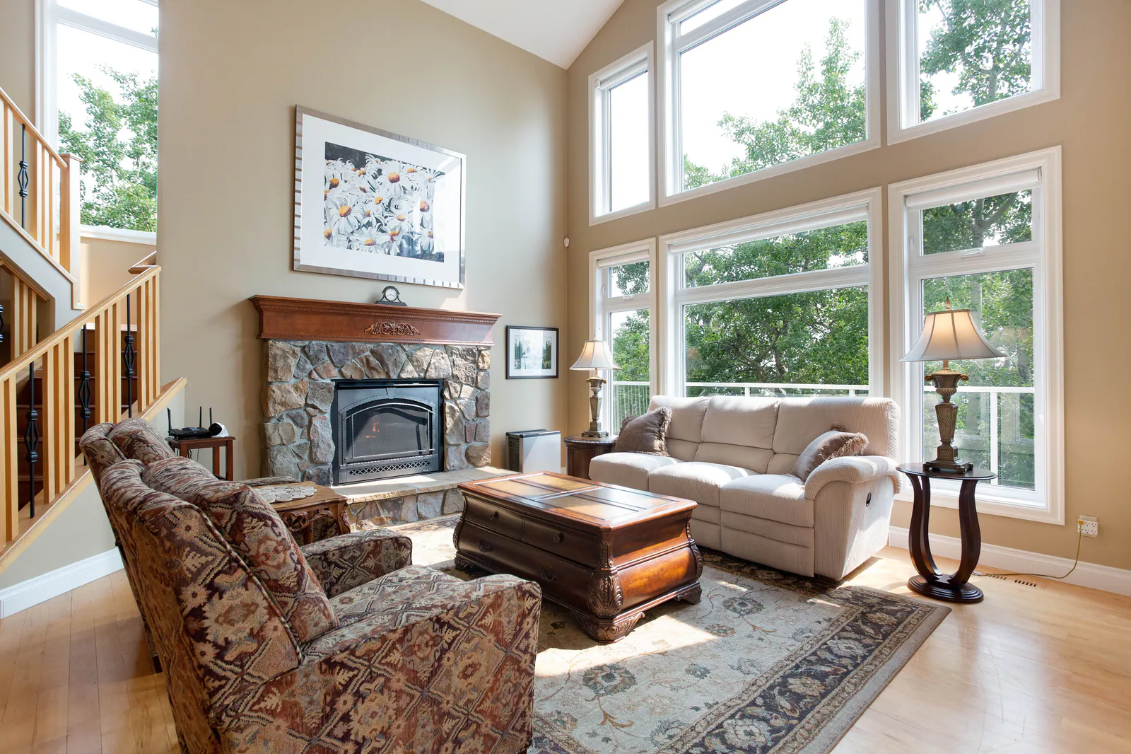 Great room with stone fireplace and tall windows