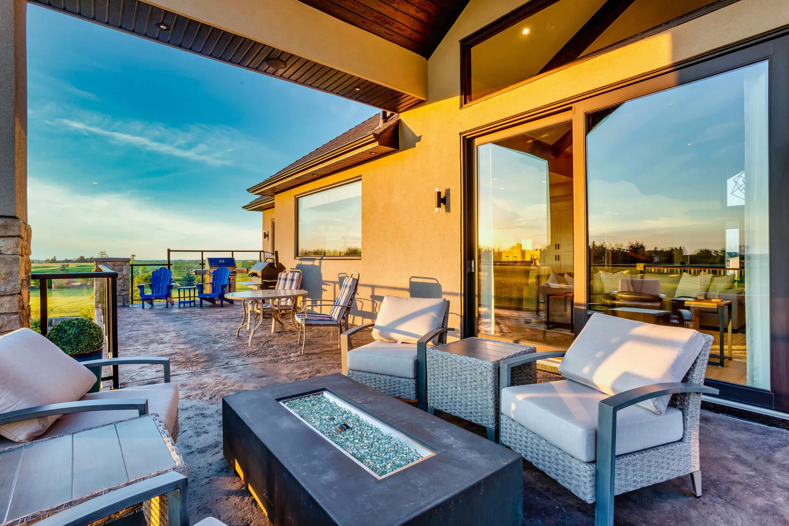 Covered west-facing balcony with a fire table overlooking the fields