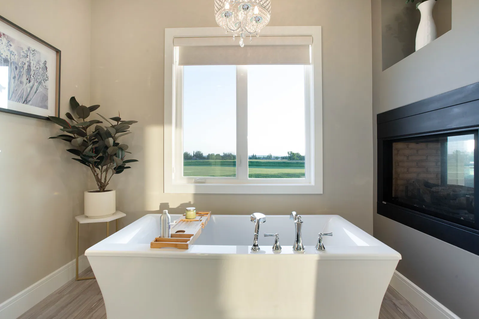 Primary ensuite with a freestanding tub beside a fireplace